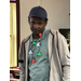 A man smiles suspiciously at the camera while wearing a light-up Christmas-colored necklace