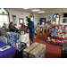 Workers organizing toys along the pews of a church