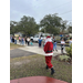 Santa Claus walking toward a line of parents with children