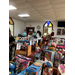 People walking through a church filled with toys