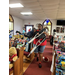 A woman carries a child with crutches through the church filled with toys