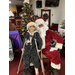 A child with crutches sits on Santa's lap