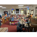 toys fill all of a church's pews and overflow onto the ground