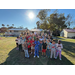 a large group of children stand for a group photo outside